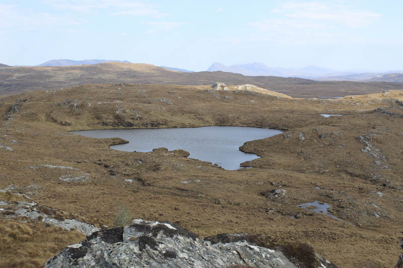 Unnamed lochan north of Meall an Duibhe. In the distance right Ben More Coigach